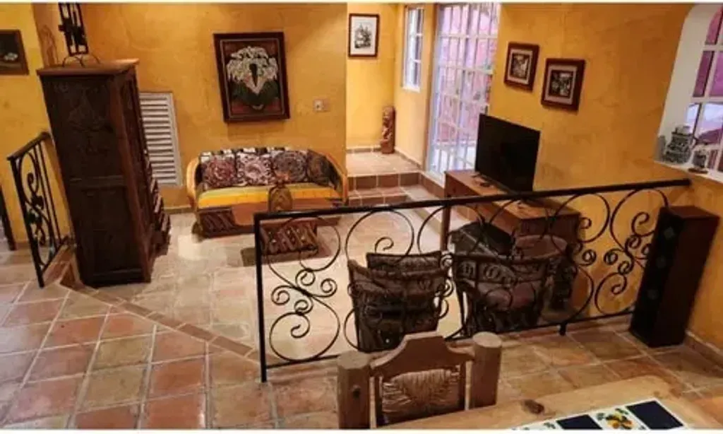 Casa Colonial, Cozumel — Casa Colonial is situated in a quiet residential neighborhood in San Miguel de Cozumel, offering an authentic local feel. The property itself is a private full-estate villa with a gated entry, featuring tropical gardens, a swimming pool, and various outdoor lounge areas. It's within walking distance to local cafes, providing a blend of serene privacy and easy access to local life.