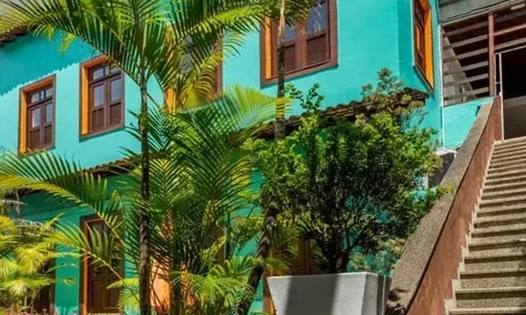 casaJOMO LTDA — Perched in the scenic Santa Teresa hills, the center occupies a charming 1930s, three-level Spanish villa. It boasts breathtaking views of the Rio de Janeiro coast, offering a serene escape from the city's bustle while remaining close enough to enjoy its vibrant energy.