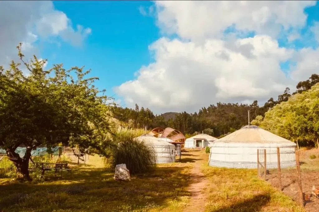 Christina Kailua — Ritmo da Terra, the venue for Christina Kailua, is a magical off-grid sanctuary located in Aljezur, Portugal. It boasts a serene natural environment with yurts, a refreshing saltwater pool, a tranquil lake, and a relaxing sauna. The ocean is just a short 15-minute drive away, offering the best of both secluded nature and coastal access.