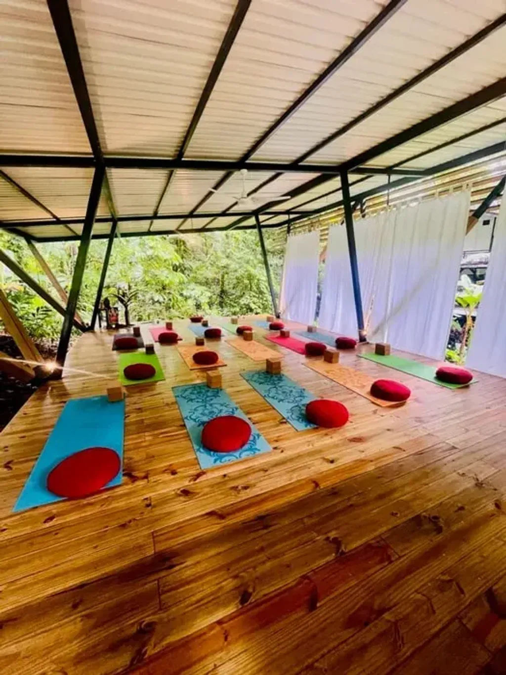 CuraTica Retreat — set in the vibrant tropical landscape of Ojochal, Puntarenas, CuraTica Retreat is surrounded by lush greenery and the soothing sounds of nature. The property features tranquil outdoor spaces, including a nearby river and hammocks located into the garden, creating an atmosphere of peaceful relaxation and connection with the natural world.