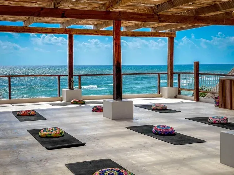 Erin Newman Group LLC — The retreat unfolds at the Amansala Eco-chic Resort and Spa, set on the vibrant Tulum Beach in the Zona Hotelera. This coastal setting offers a blend of natural beauty and a relaxed, upscale atmosphere, with the Caribbean Sea providing a serene backdrop for reflection and rejuvenation.