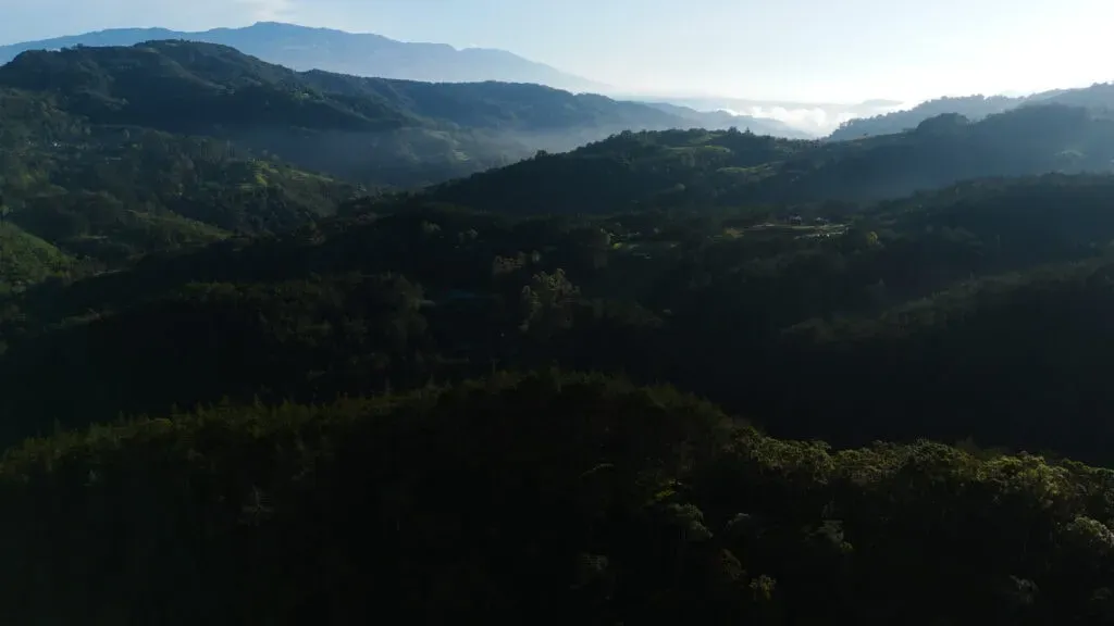 Grassroots Wellness LLC — This retreat is set within a breathtaking 105-acre regenerated cloud forest and hummingbird sanctuary in the mountains of central Costa Rica. The landscape is characterized by mist-shrouded mountains, a flowing river, and an explosion of tropical flowers, creating a serene and deeply natural atmosphere conducive to healing and reflection.