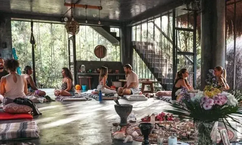 HEALING RETREAT MEXICO — The retreat is set within a historic 400-year-old Mexican Hacienda, enveloped by the vibrant Yucatan jungle. Guests are constantly surrounded by nature and local wildlife, with facilities thoughtfully designed to blend into the environment. Lush gardens and natural elements create a serene and immersive atmosphere.