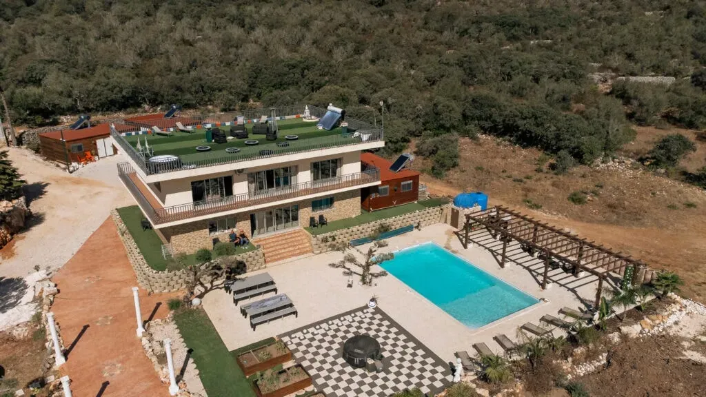Healthy Built Life — Located in the scenic Marques region of Portugal, the center is surrounded by gardens and offers a refreshing environment conducive to physical activity and relaxation. The facilities are designed to blend indoor and outdoor experiences, from a rooftop bootcamp terrace to a sunrise workout deck, all within a peaceful Portuguese landscape.
