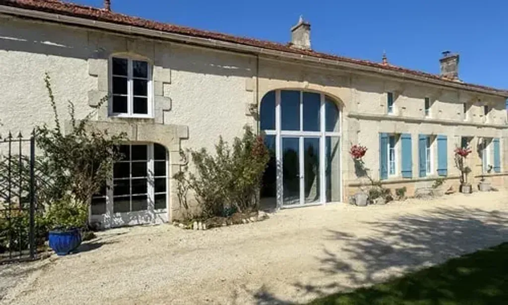 House of the Hollyhocks — The retreat is set in the serene Charente-Maritime countryside of France, offering a peaceful escape. The outdoor spaces include a refreshing pool, a firepit area well suited to evening gatherings, and a pretty garden, all contributing to a tranquil and inviting atmosphere.