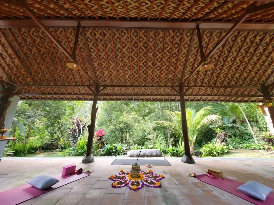 In Moment with Yoga — The retreat is situated in Gianyar, Bali, surrounded by verdant landscapes and traditional rice fields. This tranquil environment offers a peaceful escape, allowing guests to fully immerse themselves in nature's serenity. It's a hideaway designed to disconnect you from external distractions, providing a calm and restorative atmosphere.