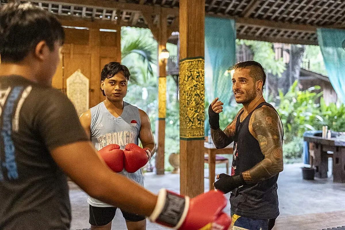 Kaizen MMA — set in the peaceful nature of North Bali, the retreat is surrounded by lush tropical greenery. Guests can enjoy access to walking paths and scenic spots, with a tranquil garden environment featuring a swimming pool. The open-air MMA training area allows for an immersive experience within the natural surroundings.