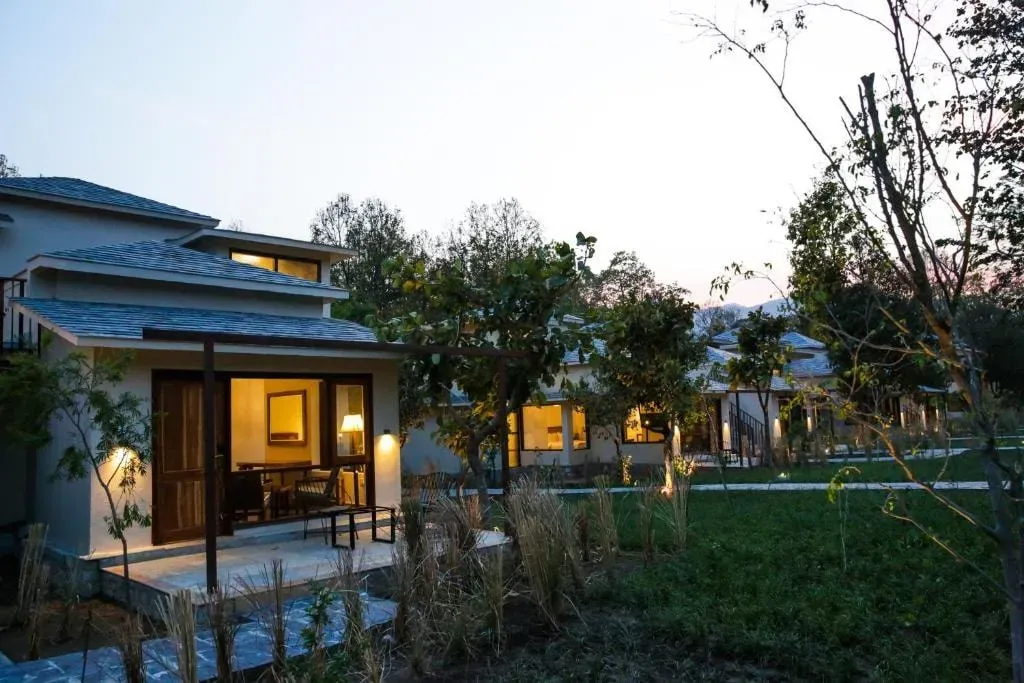 Karmic Moksha — set within the vibrant greenery of Jim Corbett, the center boasts serene views of both forest and river landscapes. The natural surroundings are integral to the experience, with outdoor meditation and yoga areas designed to immerse guests in nature's tranquility. Open-air dining spaces further enhance this connection, offering authentic meals with a scenic backdrop.