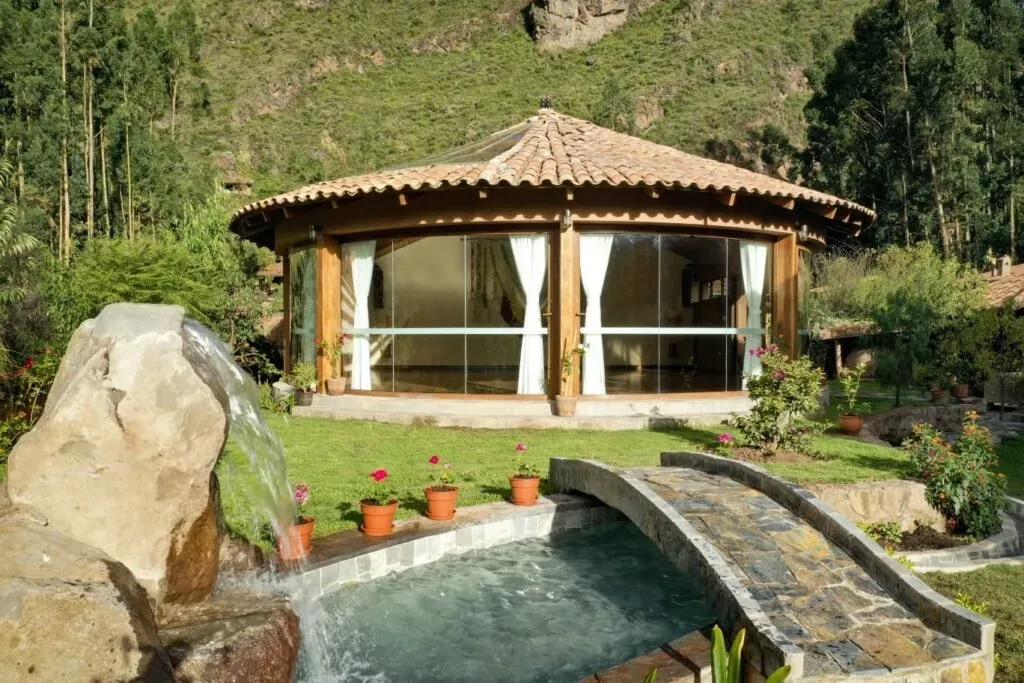 Kevin Shroads and Camilla Balboa — Located by the river on the outskirts of Pisac in Peru's Sacred Valley, the center offers a serene natural environment. The exact address is provided upon registration, suggesting a private and focused setting away from the main town bustle.