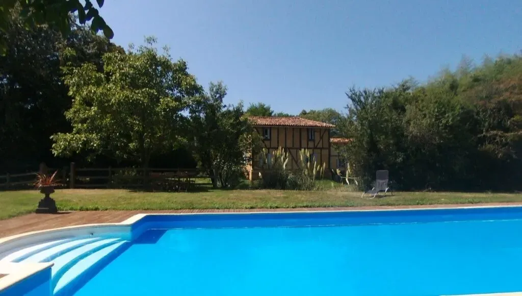 Le Betet - an oasis of tranquility — Le Betet is set within 27 hectares of picturesque pasture and woodland, surrounded by the rolling countryside of Gers, France. The landscape is characterized by fields fringed with oak trees, creating a serene and calming atmosphere that encourages reconnection with nature.