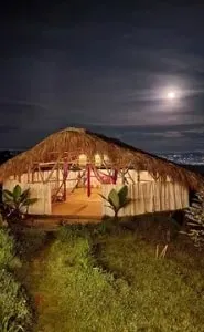 Madre Cocoon — Madre Cocoon is situated in the Vereda la Palma area, near Medellin, Colombia. The venue is designed to immerse guests in a serene natural environment, characterized by rustic charm and lush surroundings. It offers a tranquil escape where the embrace of nature guides visitors back to a sense of inner peace and connection.