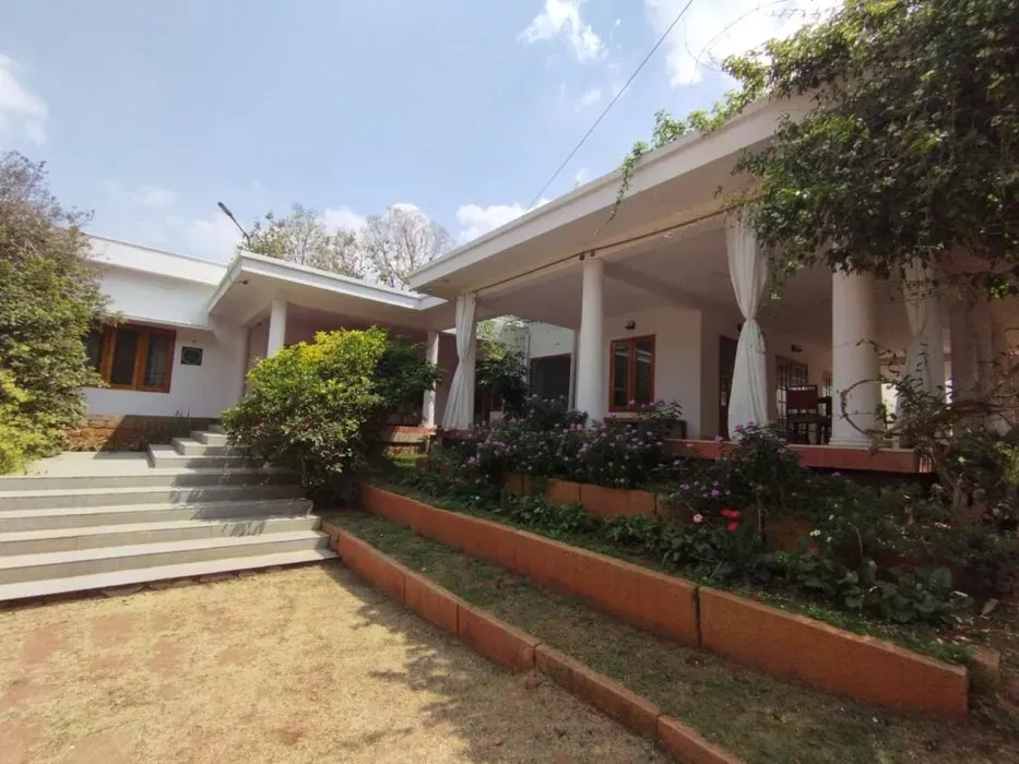 Manasthala Mindful Living — Manasthala Mindful Living is set in the peaceful Gokulam neighborhood of Mysuru, surrounded by lush greenery. The venue offers a serene atmosphere with open lawns for community gatherings, providing a balanced environment for comfort and simplicity.