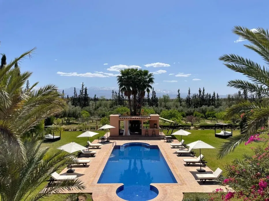 Mayfly Maven — The retreat unfolds at Ryad Azaly, a serene sanctuary set just 15 minutes outside the bustling center of Marrakesh. Guests can enjoy impressive gardens and expansive views, providing a peaceful backdrop for relaxation and introspection. The proximity to Marrakesh also offers an exciting opportunity to venture into the city's magnetic energy, exploring its famous souks and cultural hotspots.