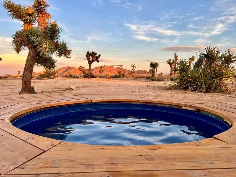Mel Daly — set within five acres of the iconic Joshua Tree desert, the retreat offers panoramic views of the unique landscape. The atmosphere is one of profound serenity, with endless Joshua Trees stretching into the horizon. It's a place designed for quiet contemplation and deep connection with nature, far from urban distractions.