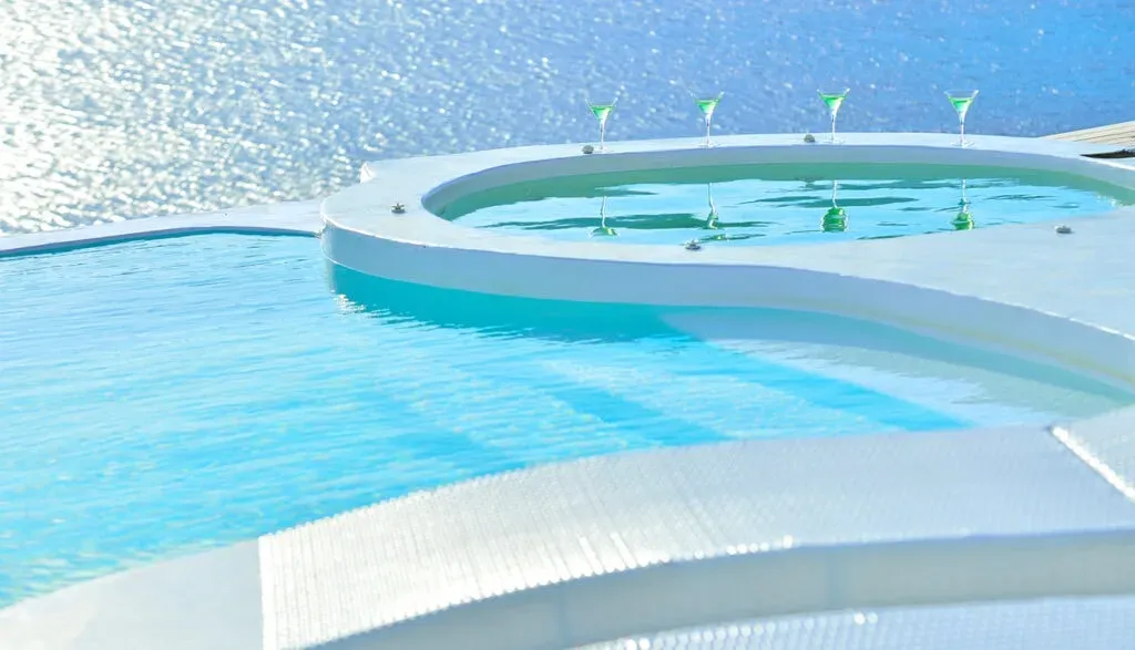 Mykonos Pantheon Luxury Suites — The Mykonos Pantheon is situated in Kalo Livadi, on the northern side of Mykonos. The venue boasts breathtaking panoramic sea views that are visible from the suites and private patios. Guests have easy access to the beautiful Loulos beach, the popular Kalo Livadi beach, and the Solymar Beach Restaurant, all within walking distance. The local beaches are characterized by white pebbles and clear azure waters, offering a serene and picturesque environment.