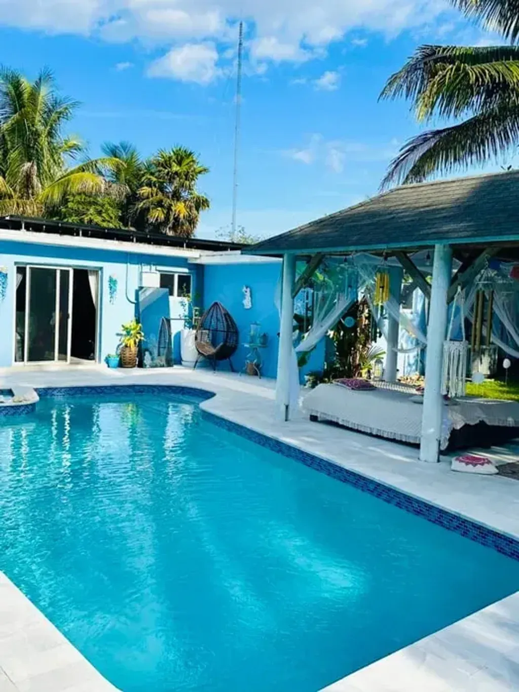 Nature Delivered Wellness Sanctuary — set within a residential area of Miami Gardens, the sanctuary provides a surprisingly serene natural environment. Guests can enjoy the calming presence of nature, enhanced by a pool, a relaxing spa, and a wind chimes gazebo, creating an atmosphere conducive to peace and introspection. The presence of on-site fruit and herb gardens further grounds the experience in natural abundance.