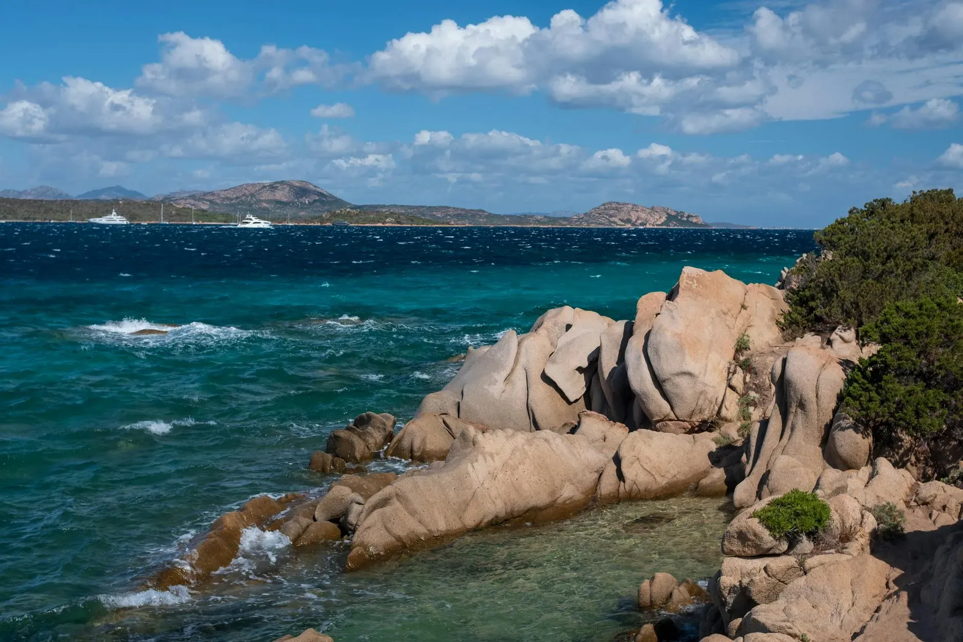 Navika Sailing — The setting for Navika Sailing is the stunning coastline and turquoise waters surrounding Olbia, Sardinia. Guests will spend their days exploring remote bays and the underwater world, with nights anchored under the stars. The catamaran itself provides a luxurious and open environment, blending seamlessly with the natural beauty of the Mediterranean.