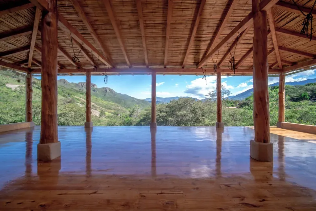 Nilaya Yoga — Perched on a small hill, the Izhcayluma Eco Lodge offers sweeping views of the Vilcabamba valley, renowned for its longevity. The grounds feature extensive subtropical gardens, alive with a variety of flowers, trees, and watercourses, creating a vibrant habitat for numerous butterflies and birds. This natural beauty provides a tranquil backdrop for reflection and connection.