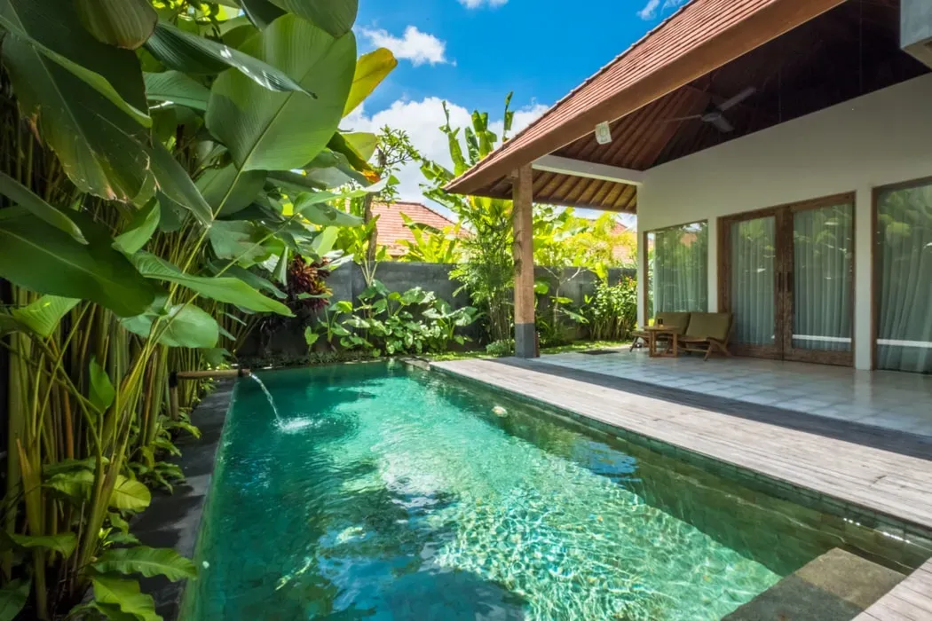 Purana Boutique Resort — The resort is situated in a private villa just 2 kilometers, or about a 10-minute drive, from the bustling center of Ubud. This provides a peaceful sanctuary away from the crowds while still offering easy access to the town's cultural attractions and amenities. The villa boasts a wide balcony, well suited to individual yoga sessions amidst the tranquil Balinese landscape.