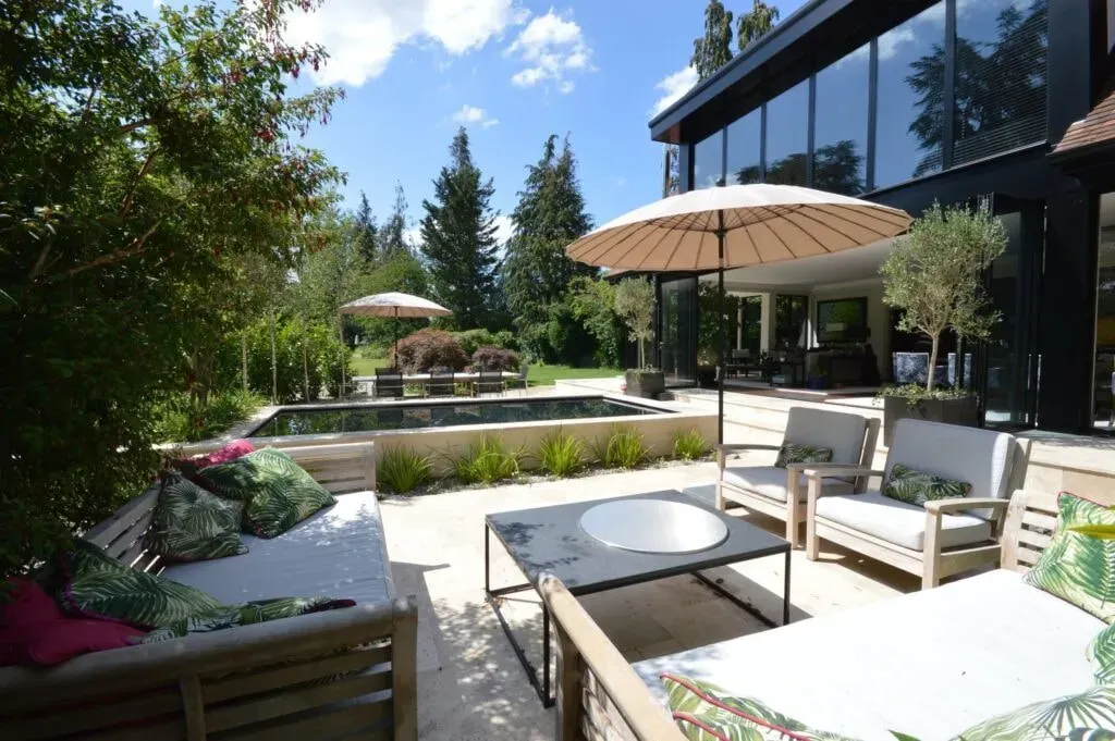 Radiant Alchemy Retreats — The retreat is set in a luxury house on the river in Wooburn Green, Buckinghamshire. The long garden extends down to the water, offering tranquil views of meadows on the opposite bank. Features like a riverside jetty with a fire pit and a meditation orb create a peaceful and exclusive atmosphere.