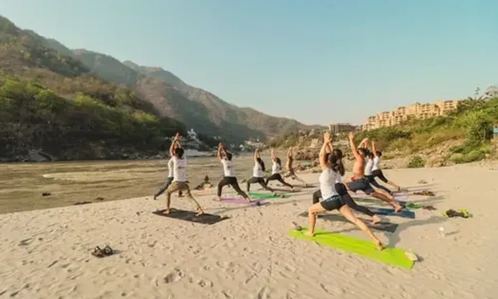 Rishikesh Yog Nirvana — Rishikesh Yog Nirvana is situated in the scenic mountains of Tapovan, Rishikesh, offering a peaceful environment conducive to yoga and meditation. The center itself features a yoga studio, dining area, and chill-out zones, with a beautiful rooftop providing views of the surrounding landscape. A local market is conveniently located a short walk away.