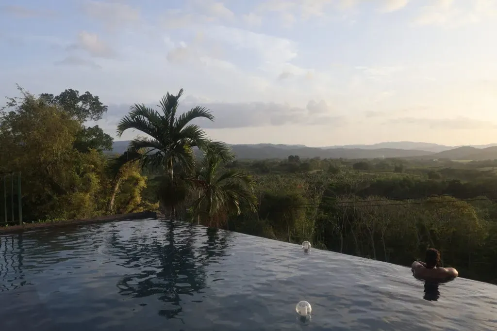 Sacred Ground Retreats — The retreat is set on a breathtaking 2,000-acre mountain estate in Trelawny, Jamaica. This expansive property offers a serene balance of luxury and nature, with opportunities to witness stunning sunsets over an infinity pool, wander through scenic trails, and listen to the calming flow of a nearby river. The historic grounds are enveloped by river and mountain air, creating an atmosphere conducive to deep rest and reflection.