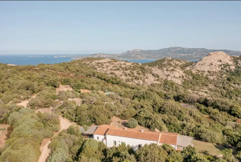Sardinia Retreats — The Mascaratu Retreat is situated in the peaceful countryside of Northern Sardinia, surrounded by granite boulders, wild herbs, and expansive skies. This landscape offers a quiet, grounding presence, just a short drive from the coast. The traditional architecture blends seamlessly with the natural environment, fostering a sense of calm and connection to the island's rhythm.