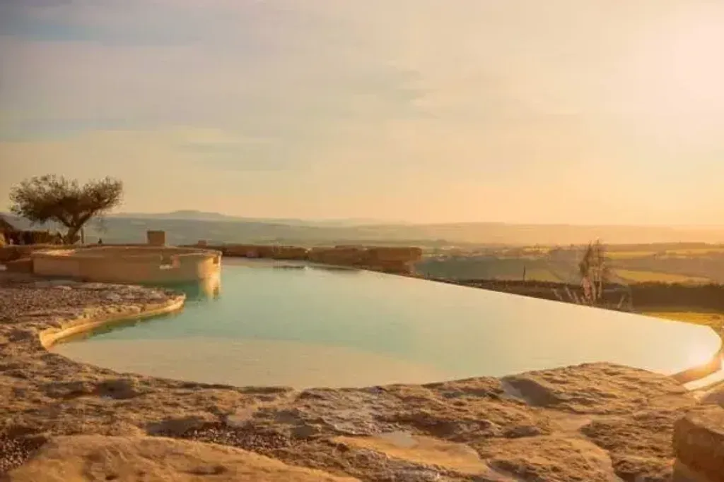 S'Entu — S'Entu is set in the heart of inland Sardinia, surrounded by unspoiled nature. The atmosphere is one of serene relaxation, offering a escape from the everyday hustle. You'll find a blend of natural beauty and warm, welcoming hospitality.