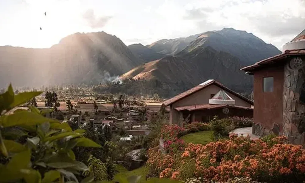 Shamballa Ayahuasca Retreats — Shamballa Ayahuasca Retreats are situated in the "valle sagrado" (Sacred Valley) of the Incas, in Huayllabamba, Peru. The center is embraced by two sacred mountains, creating an atmosphere reminiscent of a Tibetan monastery. The grounds feature winding paths through color-coded gardens, leading to a main building with a yoga space offering spectacular panoramic views.