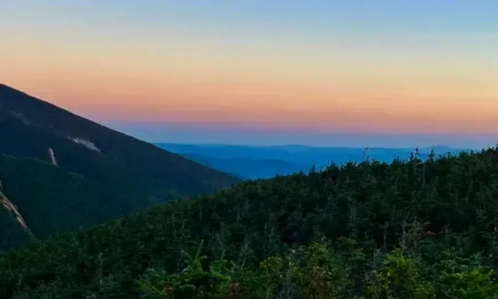 Sherpa of Souls — Sherpa of Souls operates in the stunning White Mountains, utilizing locations like the AMC Highland Center. The environment is characterized by the majestic Franconia Ridge and other iconic natural features, providing a dramatic and inspiring backdrop for mindfulness practices. This setting is designed to immerse participants in the "wild awe" of nature, fostering a deep connection to the outdoors.