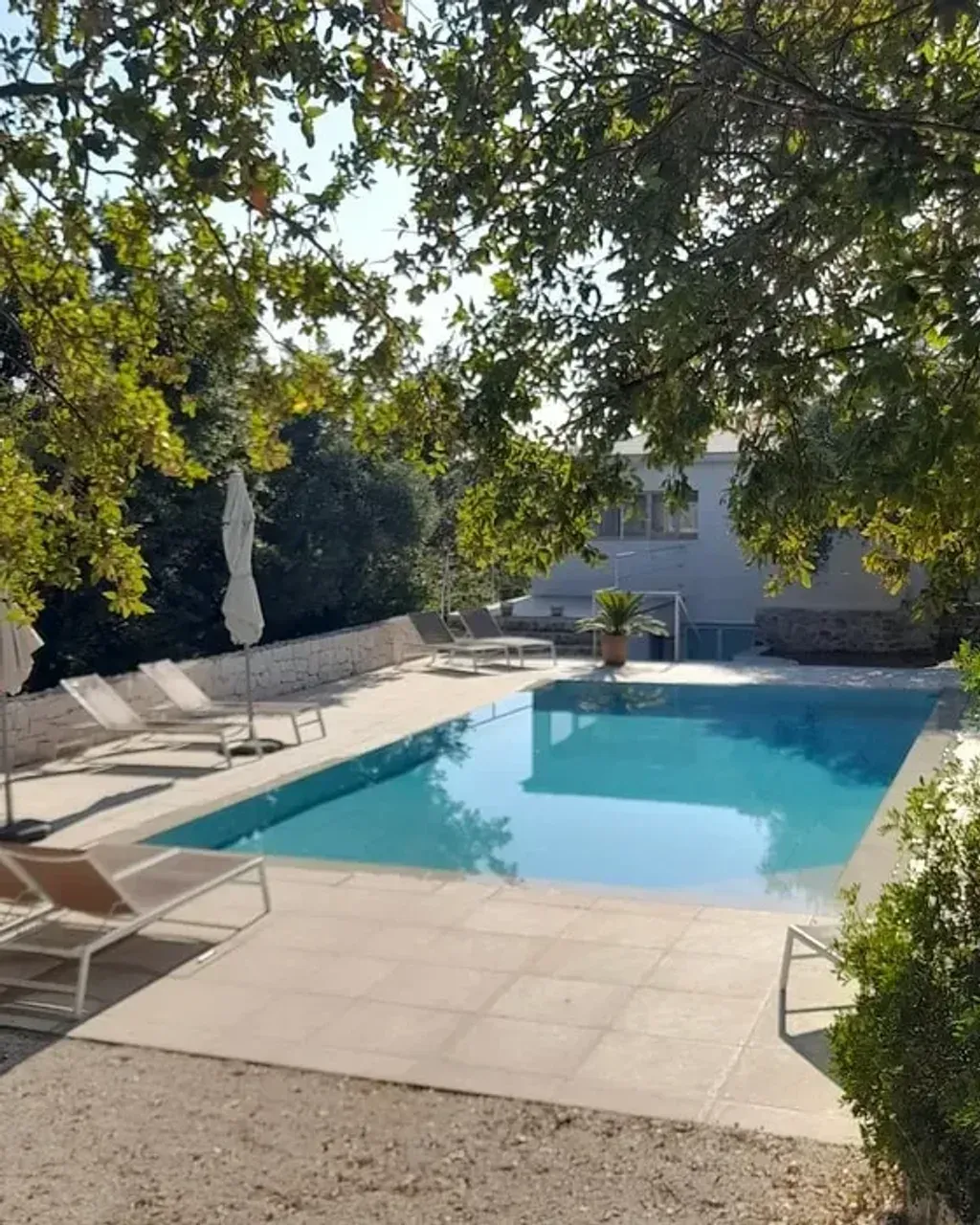 Soulbird LTD — The retreat is set in a tranquil countryside setting within the picturesque olive and almond groves of the Valle d’Itria, Puglia. The venue features restored traditional farmhouse and trullo buildings, offering a blend of historic charm and modern comfort. Guests can enjoy a light-filled courtyard and terrace for outdoor meals and reflection, a bright yoga shala with countryside views, a saltwater pool surrounded by lush greenery, and an outdoor meditation hut with panoramic vistas.