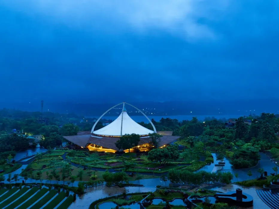 Swastik Wellbeing Sanctuary — The sanctuary is located in Maharashtra, offering a serene environment conducive to wellbeing practices. While specific details about the immediate landscape are not provided, its mission to create a sanctuary suggests a peaceful and restorative atmosphere.