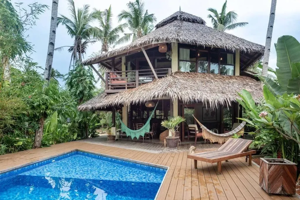 Tamara Sat Nam — Alaia Hideaway, the retreat's home, is set in the luscious foothills of Malinao, Siargao Island. It's a tropical, sustainably-designed villa surrounded by a wild forest, offering an instant connection to nature. The sounds of birds serenade guests, and uninhabited white sand beaches are just a two-minute walk away. The main tourist strip is also conveniently located seven minutes away.