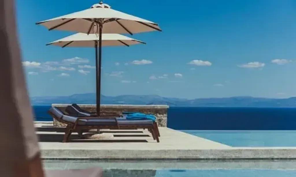 The Yoga Health Mandala — The center is situated in Leonidio, Greece, offering breathtaking views of majestic red rock mountains and the serene turquoise waters of the Aegean Sea. The atmosphere is designed for relaxation and mindfulness, blending natural beauty with modern comfort.