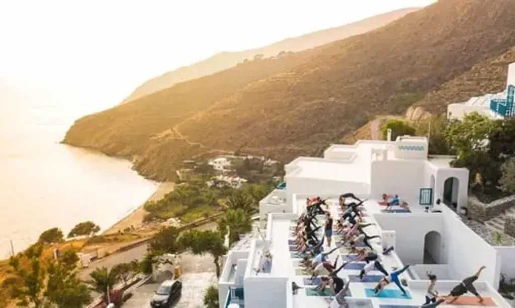 Tom Cronin — set on the picturesque island of Amorgos, the retreat offers stunning views of the Aegean Sea. The landscape is characterized by rugged hillsides, charming villages, and crystal-clear waters, providing a naturally calming and inspiring backdrop for meditation and self-discovery.