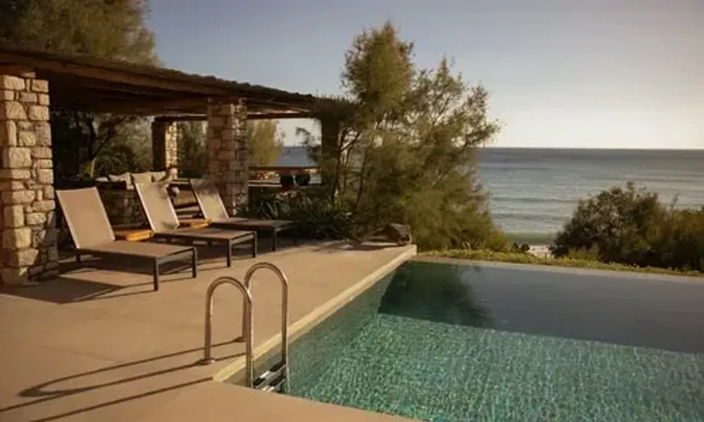 Turned On Woman Retreat — The retreat unfolds in a unique villa set in Kato Viannos, Iraklion, Greece. Surrounded by ample land, the venue offers a serene escape where you can stroll along the sea, find shade for a quiet moment, or lounge by the pool or ocean. The expansive property provides both private nooks for solitude and communal areas for connection, all against the backdrop of the Cretan landscape.
