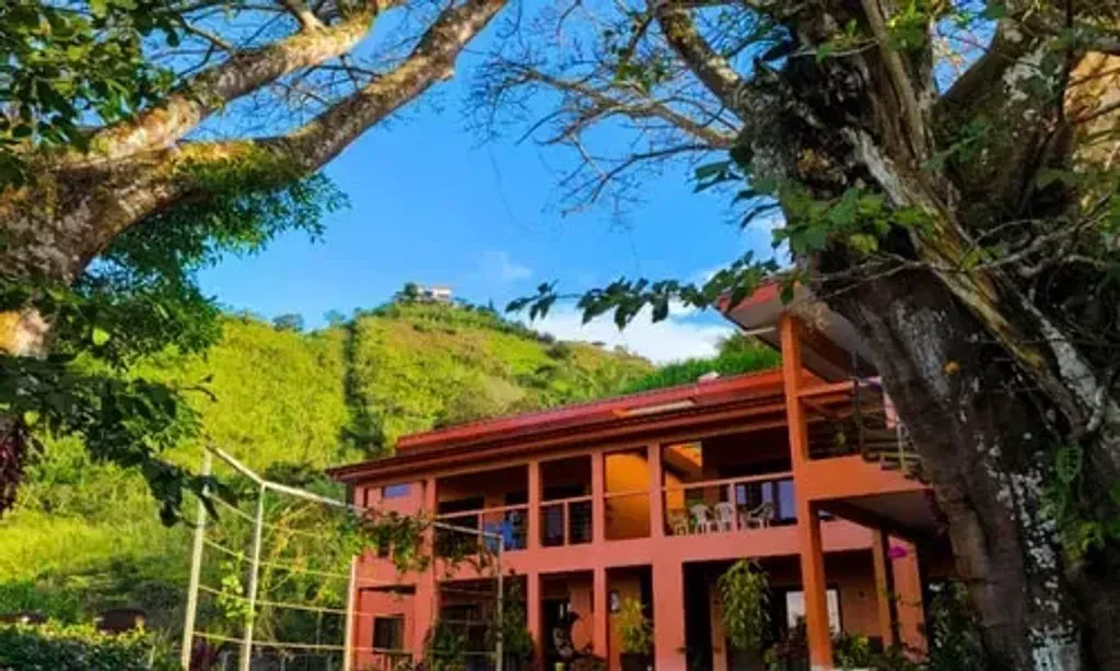 Vista Mundo Retreat Center — The center is situated in the verdant landscapes of San Ramón, surrounded by dense jungle and offering expansive mountain vistas. Peaceful garden areas with hammocks invite relaxation, while a rooftop deck provides panoramic views of the valley and stunning sunsets, creating an atmosphere of natural tranquility and serene beauty.