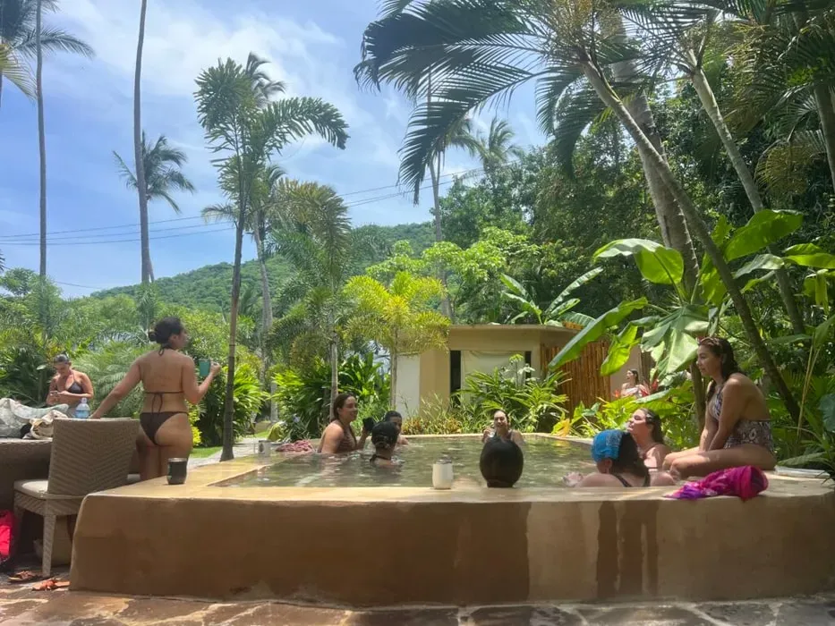 Waters Way — This retreat unfolds within a breathtaking oceanfront estate, seamlessly integrated into its vibrant jungle surroundings. The air is filled with the sounds of the Pacific and the lush tropical foliage, creating an atmosphere of natural tranquility and secluded beauty. It's a place where the wildness of nature meets refined comfort, offering expansive views and a deep sense of peace.