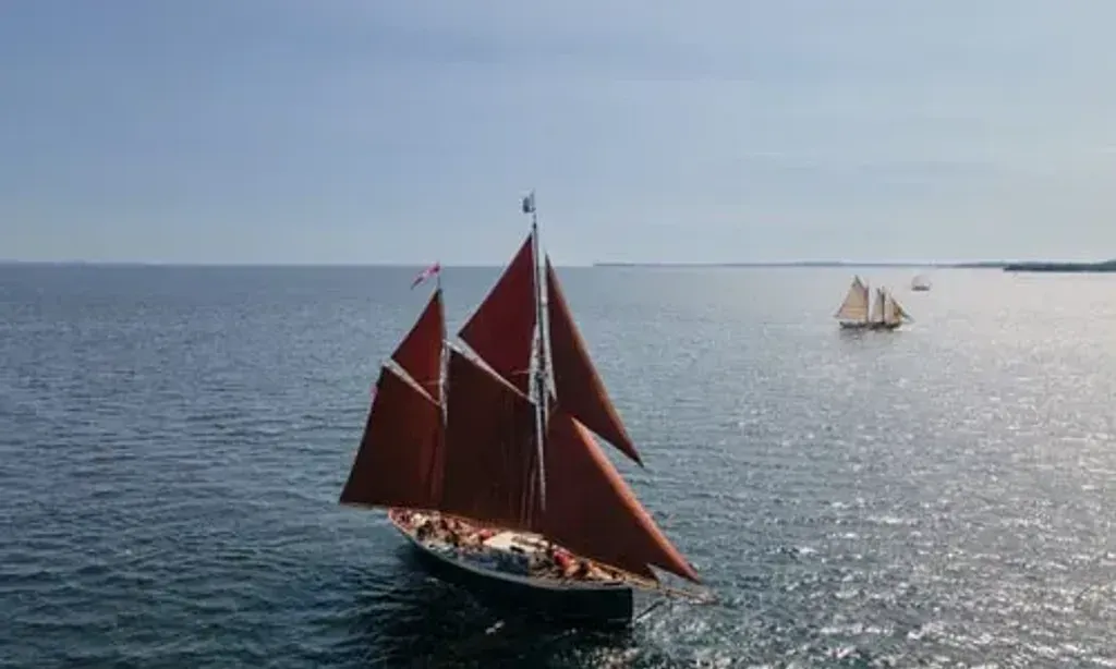 Windjammer ANGELIQUE — The Windjammer ANGELIQUE sails along the pristine coast of Maine, offering ever-changing views of the Atlantic, rugged shorelines, and charming coastal towns. The atmosphere is one of serene maritime adventure, with the sounds of the ocean and the wind in the sails providing a natural backdrop to your retreat.