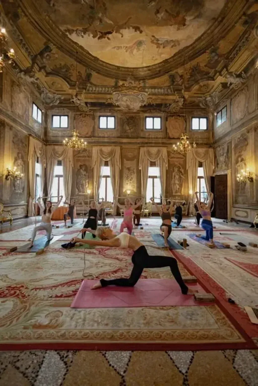 YOGALOVE — YOGALOVE is set within a magnificent ballroom of a five-star luxury hotel in Venice, a space protected by UNESCO and adorned with Tiepolo frescoes. This opulent setting provides a truly unique and inspiring atmosphere, blending historical artistry with a serene environment for yoga practice. The location on the Grand Canal offers a quintessential Venetian experience.